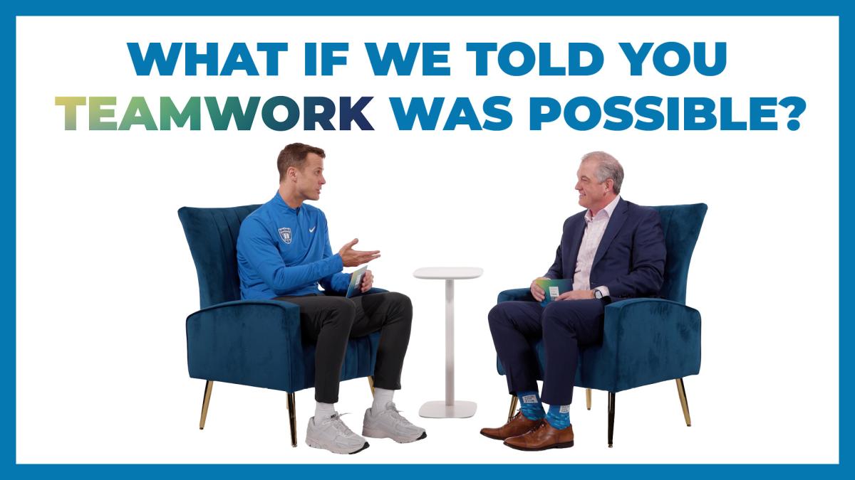 coach talks to Dr. Turek sitting in blue chair