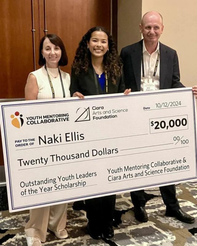 Naki Ellis receiving a Super-sized check for $20,000