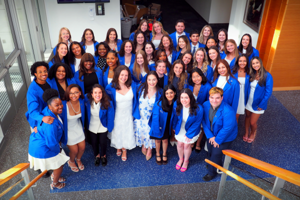 OTD students posing in their new blue coats