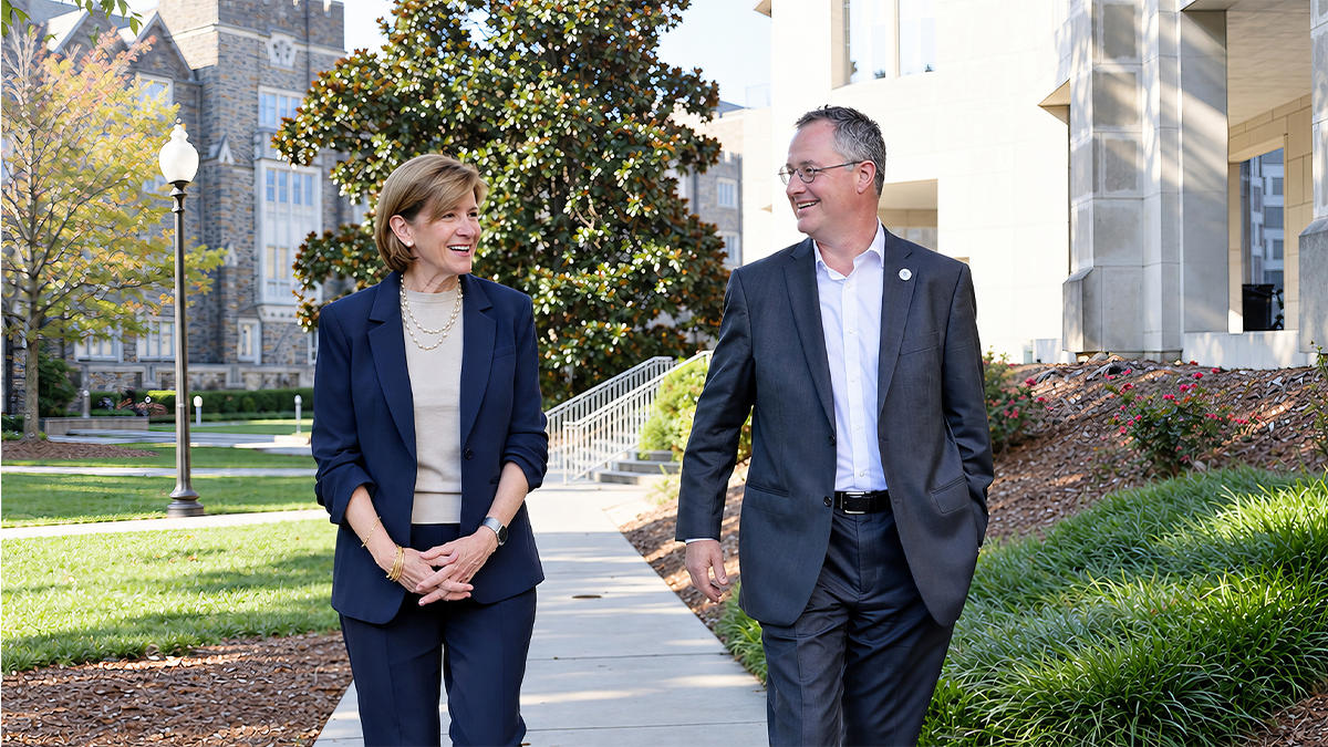 Dean Klotman and Dr. Lindsell walking on Duke Campus