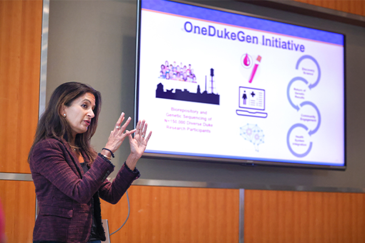 Svati Shah presenting to a screen that says OneDukeGen initiatives
