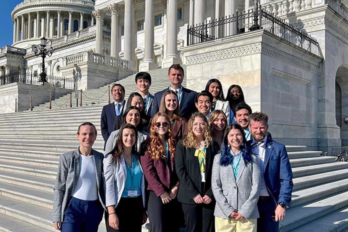 students and faculty standing on the Capitol Hill steps
