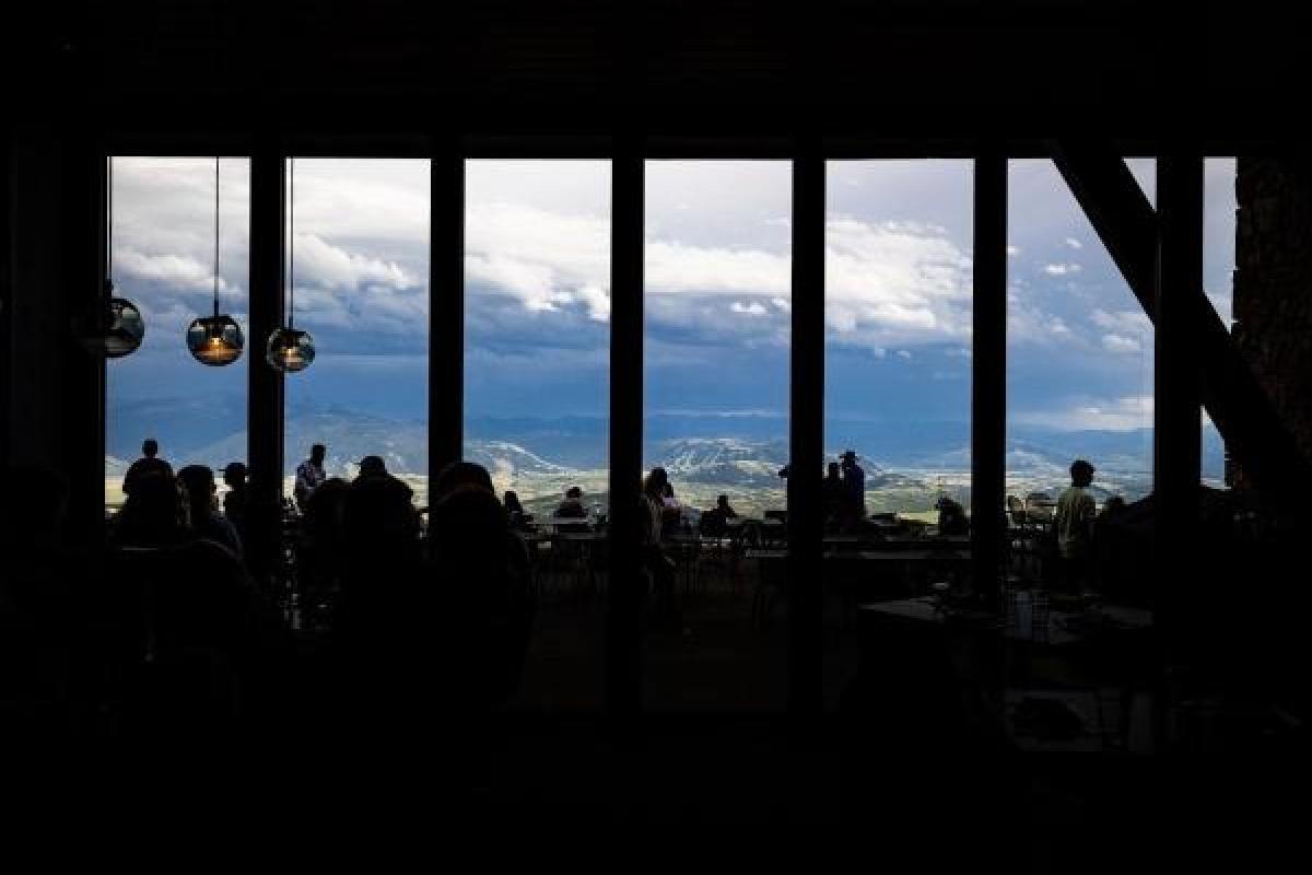 inside of a conference room with windows facing a mountain view