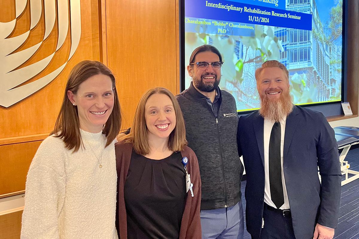 the 3 co-leaders of the Rehab Group with a speaker