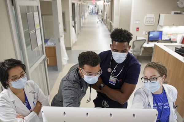 Duke Cardiology fellow rounds with other team members in the Cardiac Intensive Care Unit at the Duke Medical Pavilion