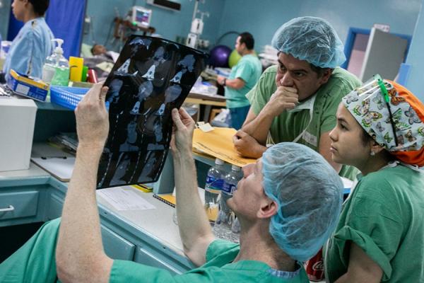 medical team looks at scans