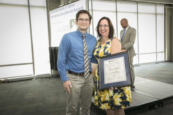 Judy Seidenstein, chief diversity officer, presents the student award to Joshua Davidoff