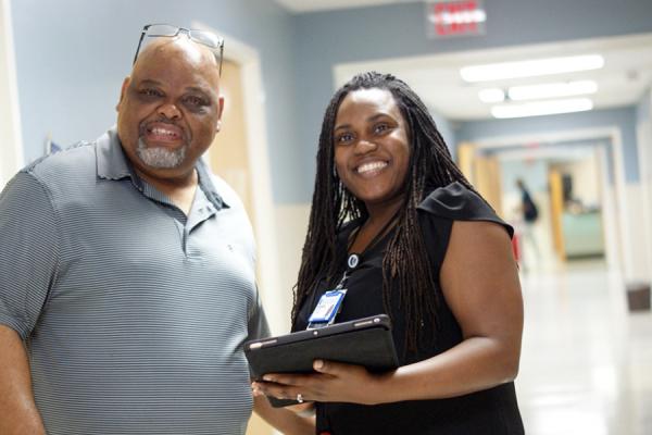 harity Oyedeji, MD, and patient standing in the clinic hallway