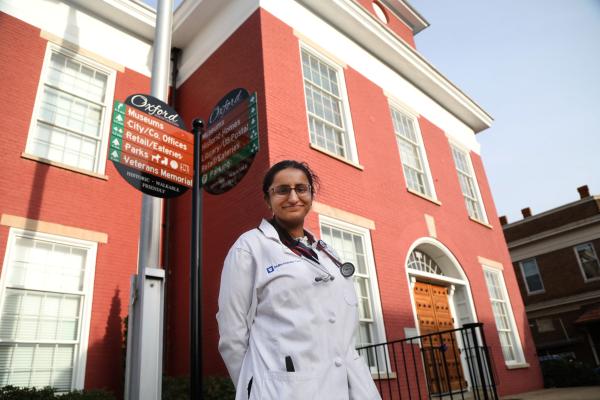 woman physician standing outside building