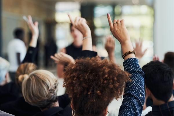 people asking questions with hands raised