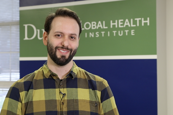 main standing infront of sign that says Duke Global Health Institute
