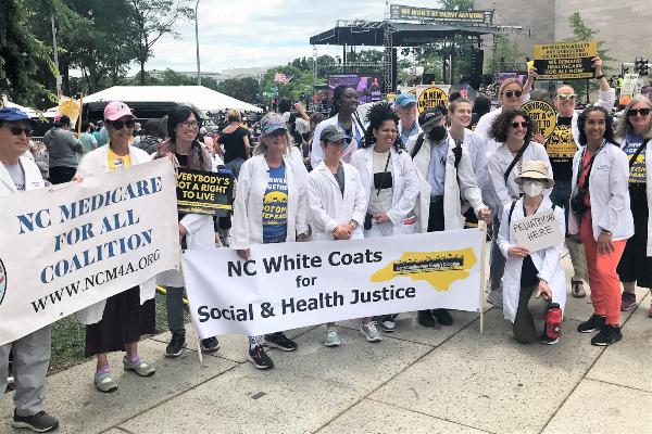 Poor People's March - Duke Faculty holding "NC White Coats for Social and Health Justice" banner