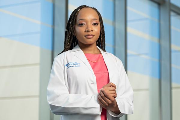 female medical student in white coat