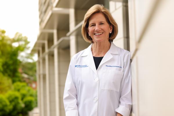 woman in white coat standing outside