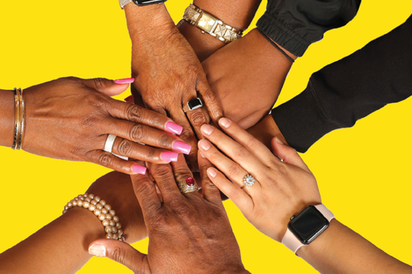 Men's and women's hands reaching into a center, some with rings and jewelry and painted nails, etc. 