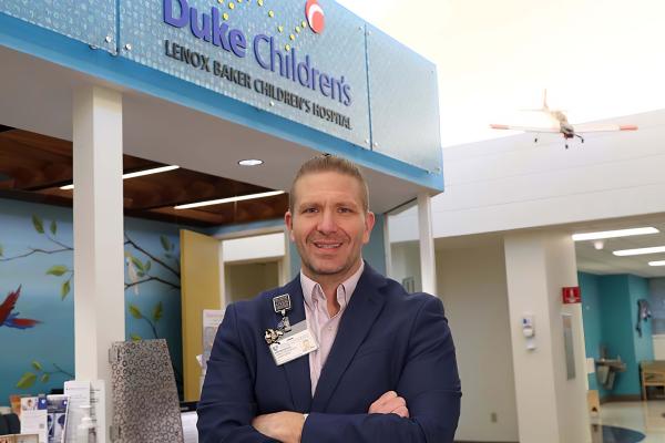man standing in lobby of Children's hospital