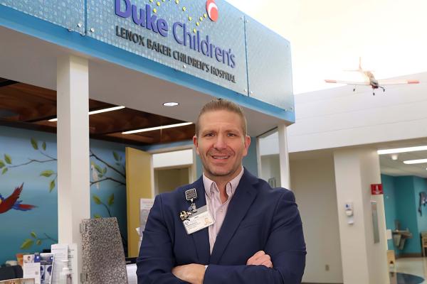 man standing in lobby of Children's hospital