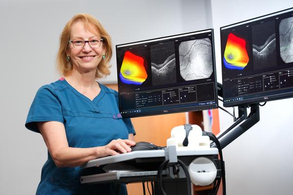 woman physician standing with imaging machine
