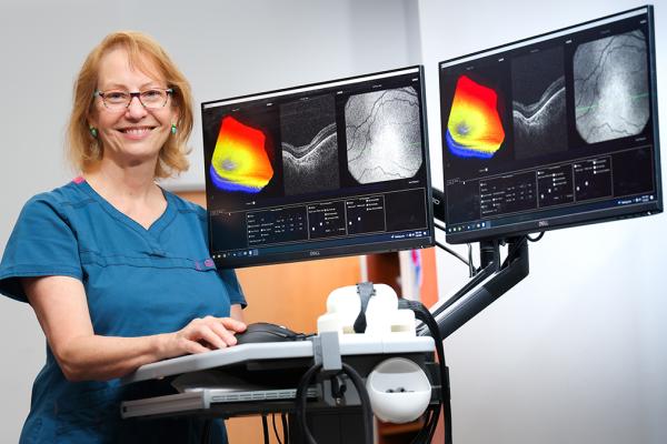 woman physician standing with imaging machine