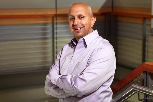 man standing on staircase with arms folded
