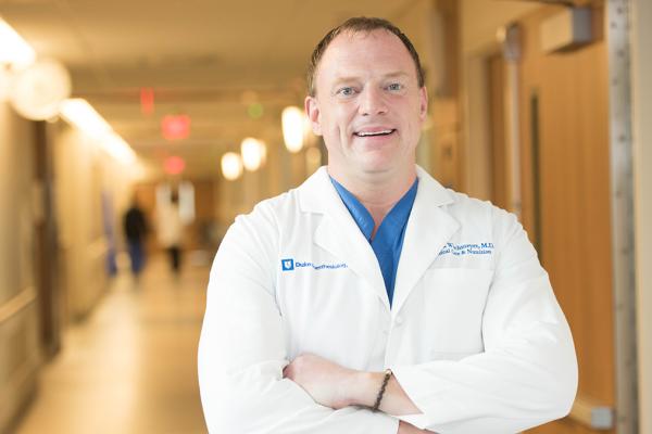 man in white coat in hallway