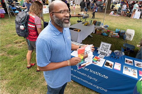 Black man tabling at Pride event