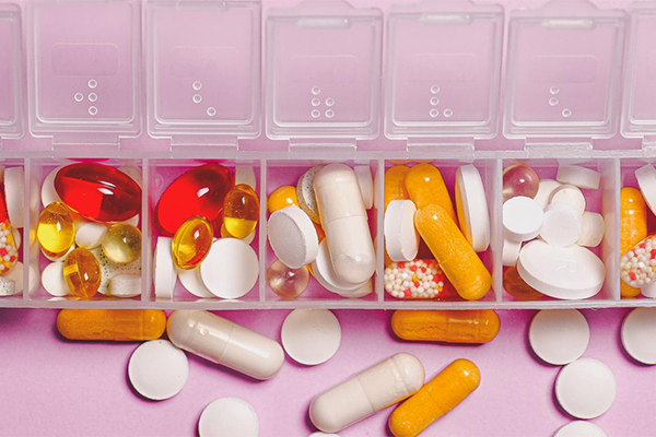 pills spilling out of a daily pill case