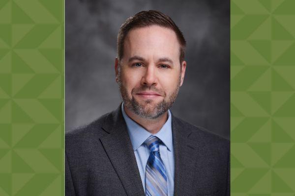 Man in a tie with a green background