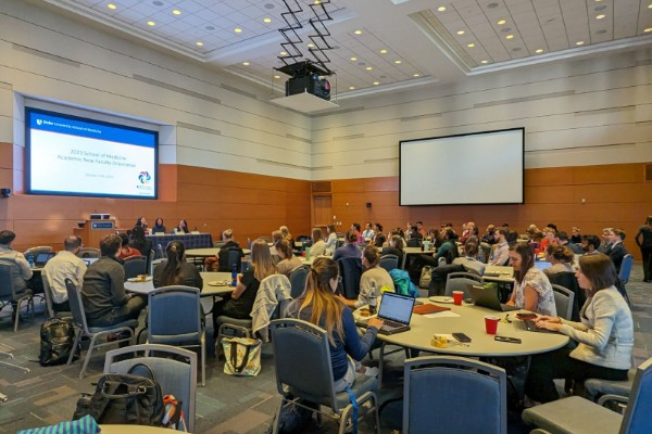 Faculty meet in the Great Hall of the Trent Semans Center