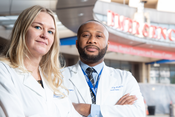 Krista Haines, DO and Anthony Eze, MD in front of the Emergency entrance to the ER at Duke