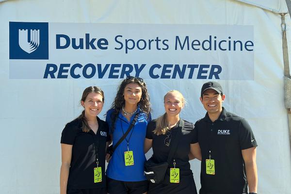 four Duke DPT students at the Duke Sports Medicine recovery tent