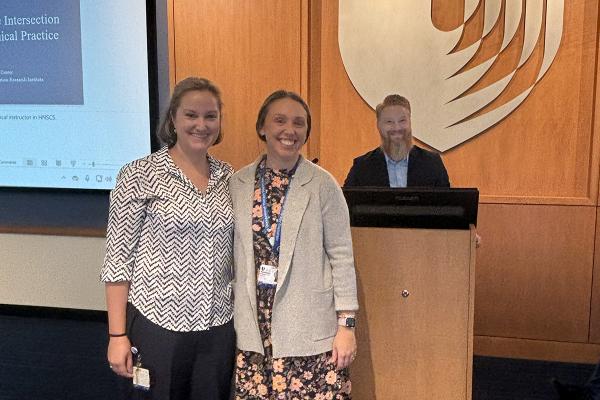 three professors at the front of the room