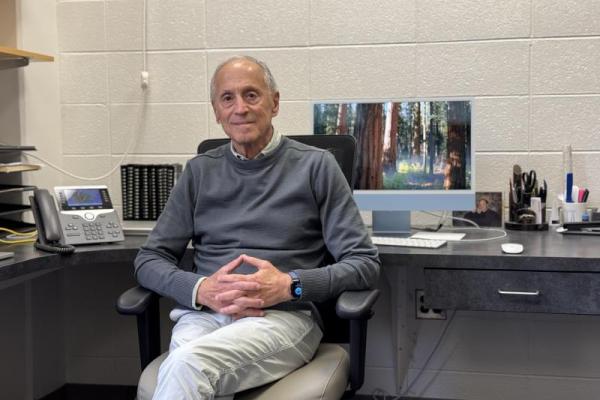 Portrait of Dr. Michael Hershfield sitting in his office