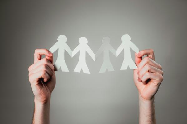 Hand holding paper cutout