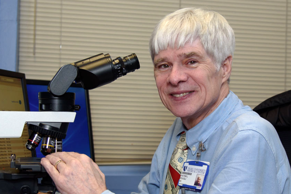 Victor Louis Roggli with a microscope
