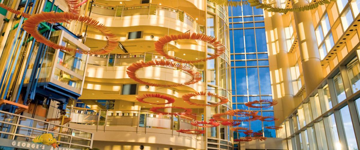 Ceiling view of the Children's hospital atrium with hanging circular artwork. 