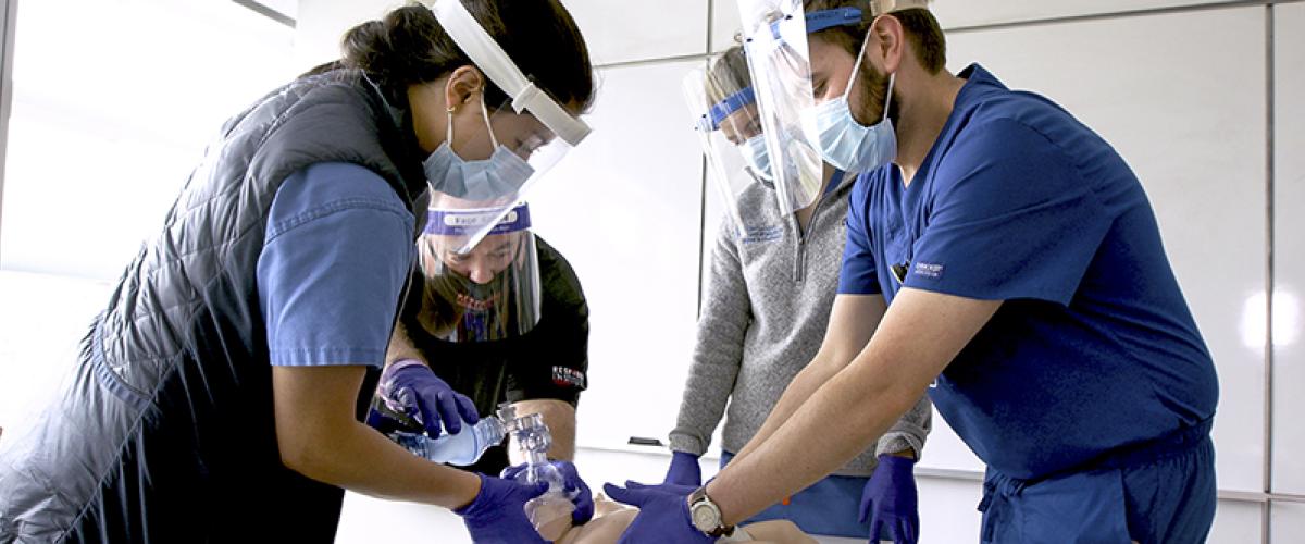 Medical students learn how to examine a baby