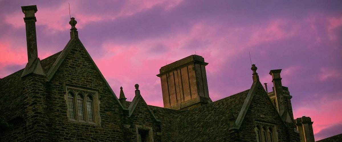 Sunset purple clouds over campus buildings
