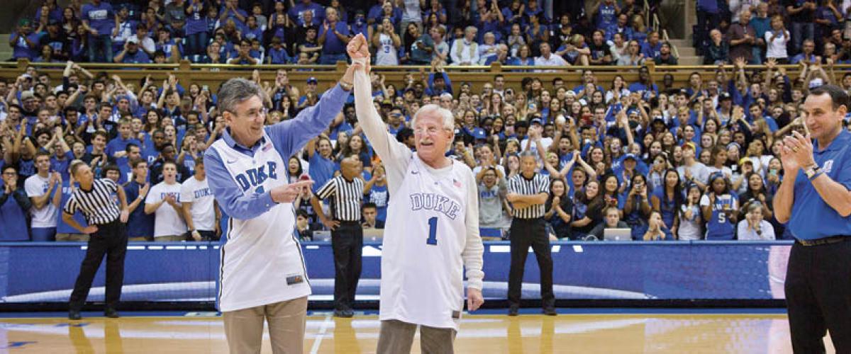 Drs. Lefkowitz and Modrich on a packed basketball court in Cameron stadium