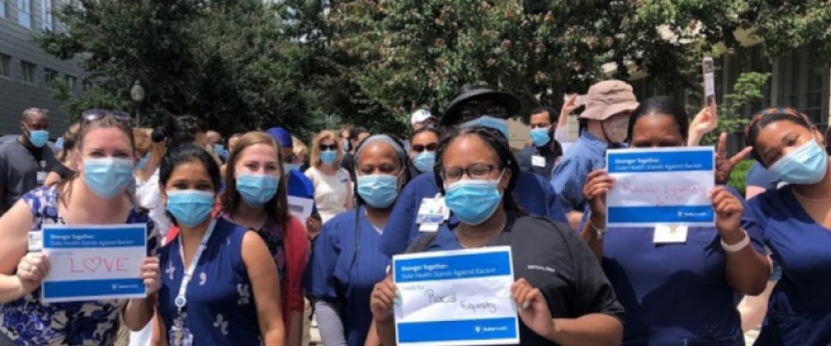 Staff holding signs at the Duke Health Solidarity march.