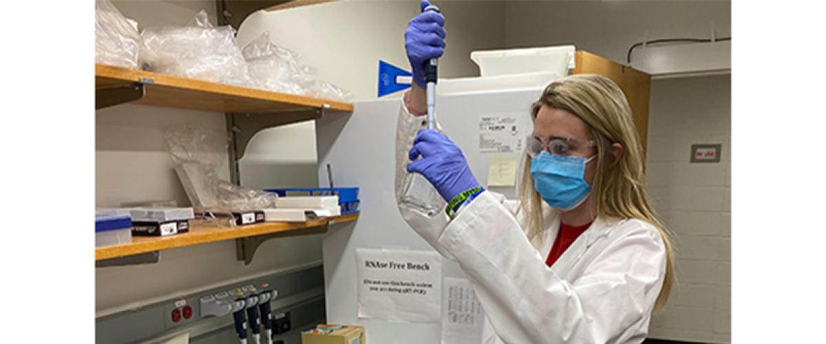 masked lab worker testing reagents