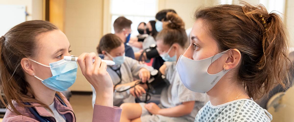 students practicing physical exams in class