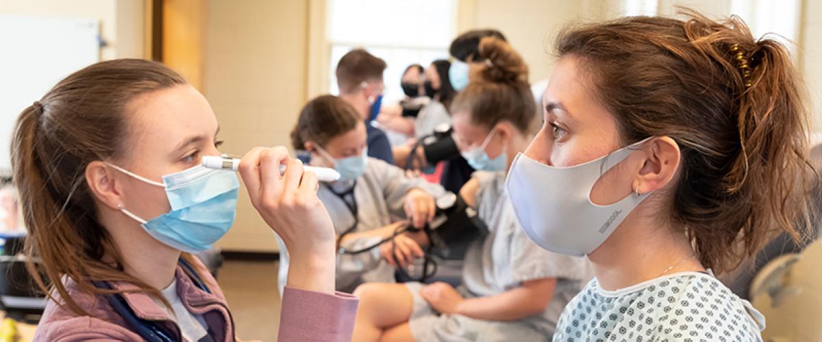 students practicing physical exams in class