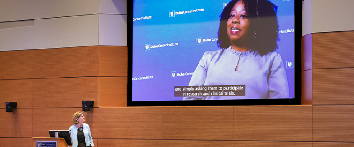 Dean Klotman presenting Nadine Barrett, PhD