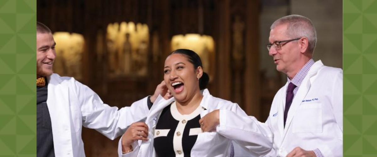 Woman getting her white coat, flanked by her peer and advisor