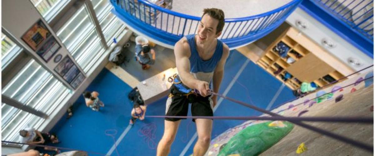 student on a climbing wall