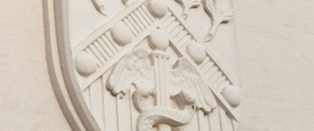 A School of Medicine Shield on an outdoor building