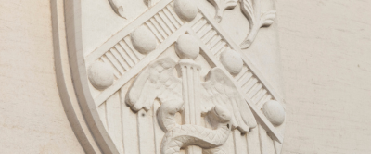 A School of Medicine Shield on an outdoor building 