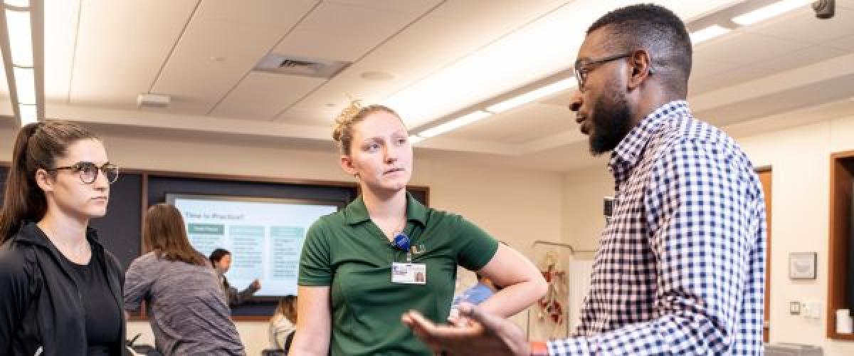 Two students and an instructor in a clinical classroom 