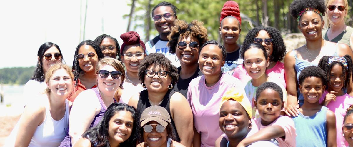 Students and staff pose for picture at the conclusion of the 2022 Annual BioCoRE Retreat on Lake Jordan